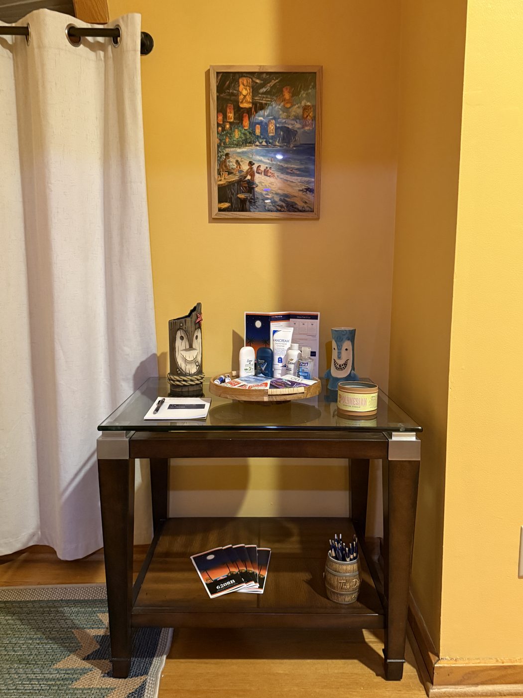 The concierge table with brochures, resort pens, complimentary toiletries, and tiki decor